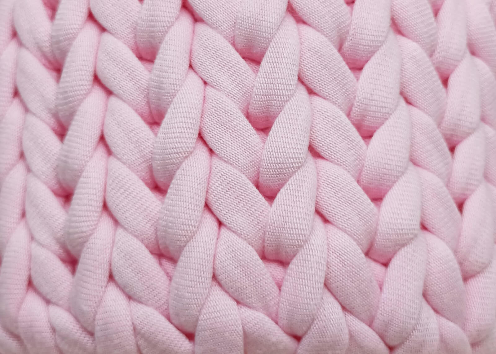 a close up of a pink knitted blanket